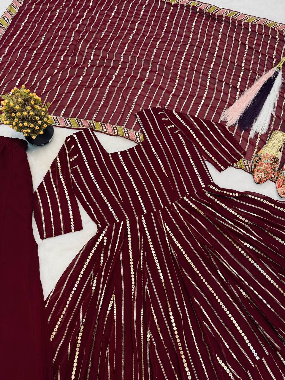 Majestic Maroon Flared Anarkali Suit Set Adorned with Luminous Sequin Stripes and an Ornate Floral Embroidered Hemline